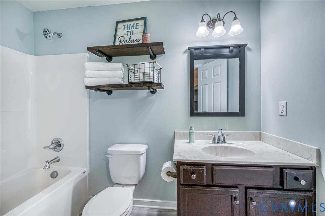 2024 Walnut Tree Place Powhatan, VA 23139 - Photo 18 of 30 a bathroom with a toilet a sink and mirror