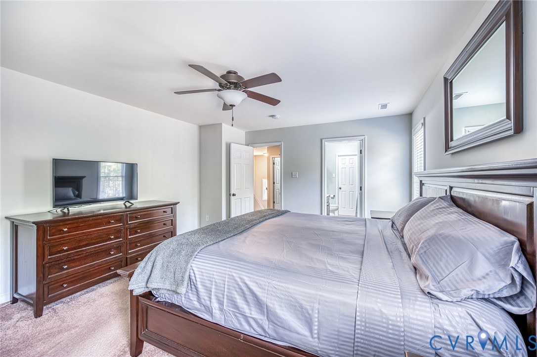 2024 Walnut Tree Place Powhatan, VA 23139 - Photo 22 of 30 a bedroom with a bed and a flat screen tv