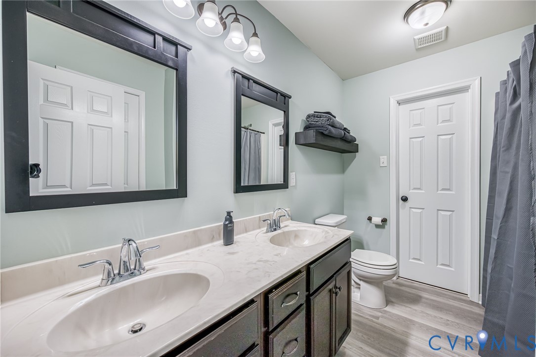 2024 Walnut Tree Place Powhatan, VA 23139 - Photo 23 of 30 a bathroom with a granite countertop sink and a mirror