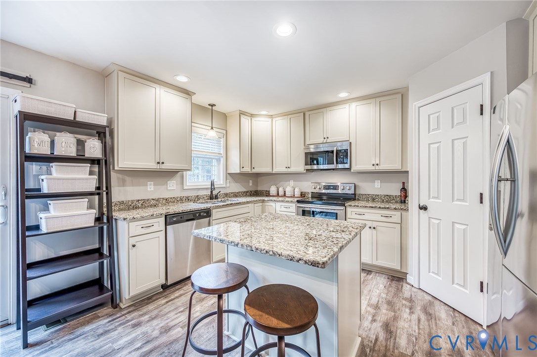 2024 Walnut Tree Place Powhatan, VA 23139 - Photo 10 of 30 a kitchen with stainless steel appliances granite countertop a stove refrigerator sink and cabinets