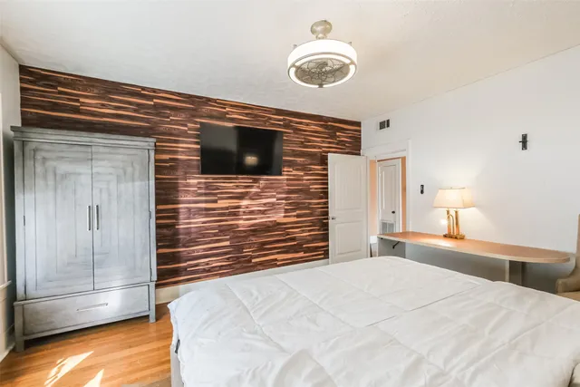 a bedroom with a bed and a chandelier