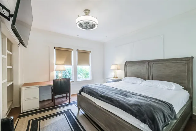 a bedroom with a bed and a chandelier