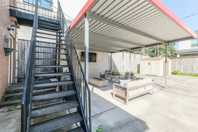 a view of a patio with couches table and chairs and wooden floor