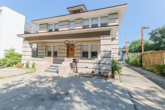 front view of a house with a bench in patio