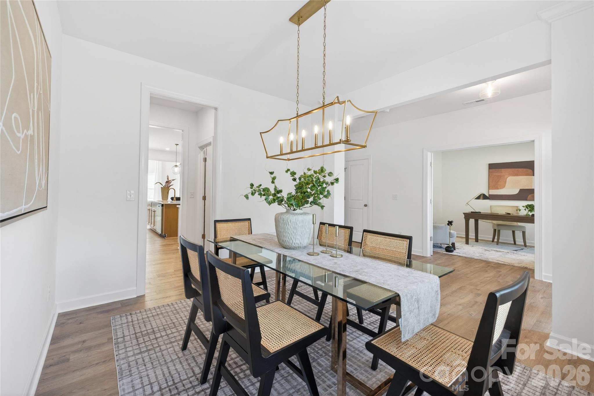 128 Overcash Road, Unit 7171 Troutman, NC 28166 - Photo 11 of 41 a view of a dining room with furniture and chandelier