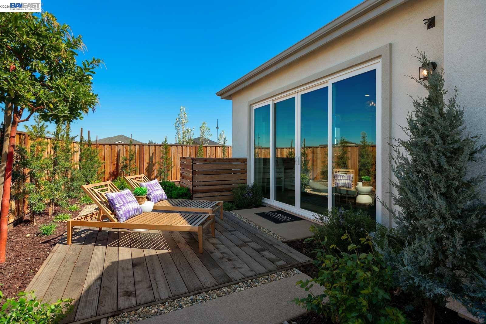 927 Conrad Street Manteca, CA 95336 - Photo 27 of 42 a view of a deck with couches table and chairs and potted plants