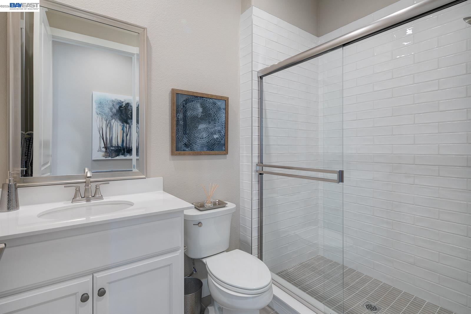 927 Conrad Street Manteca, CA 95336 - Photo 7 of 42 a bathroom with a sink a mirror a toilet and shower