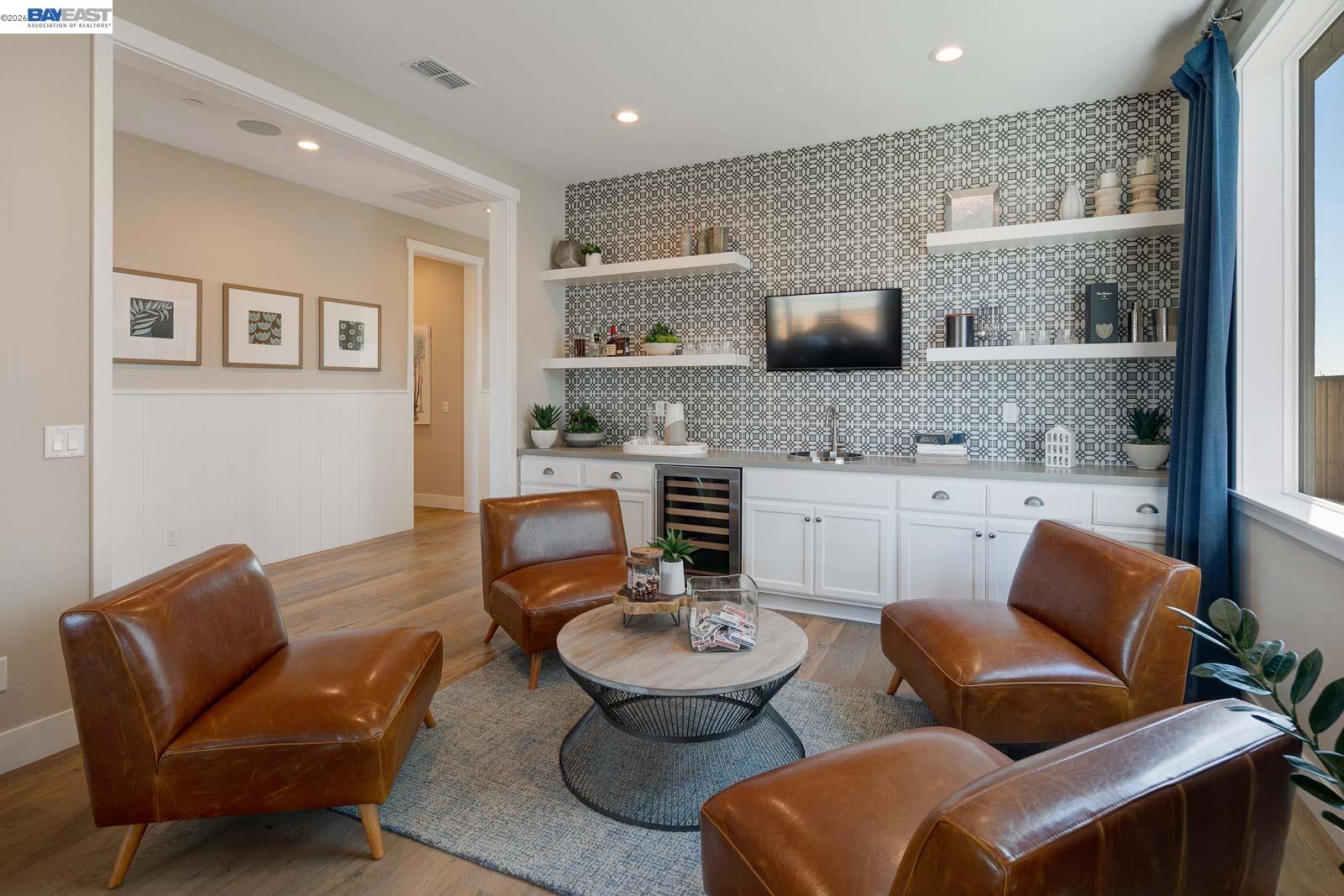 927 Conrad Street Manteca, CA 95336 - Photo 9 of 42 a living room with furniture a rug and kitchen view
