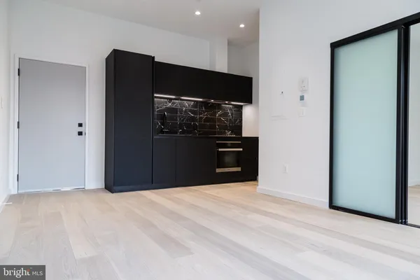 a view of kitchen with refrigerator and microwave