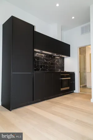 a kitchen with granite countertop a refrigerator and a sink