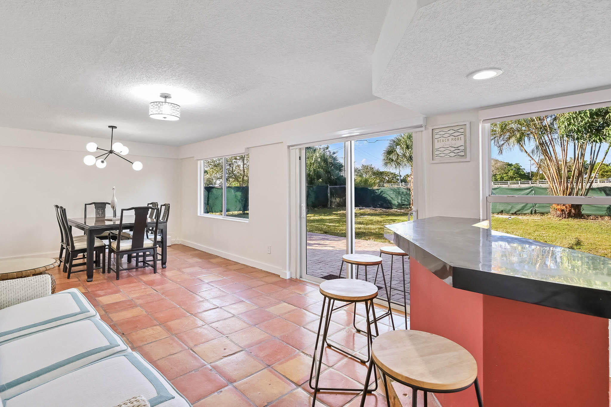 103 East Shannondale Road Cloud Lake, FL 33406 - Photo 11 of 31 a view of a dining room with furniture large windows and wooden floor