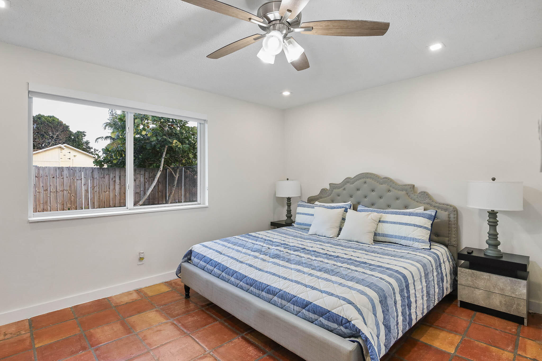 103 East Shannondale Road Cloud Lake, FL 33406 - Photo 22 of 31 a bedroom with a large bed and a window