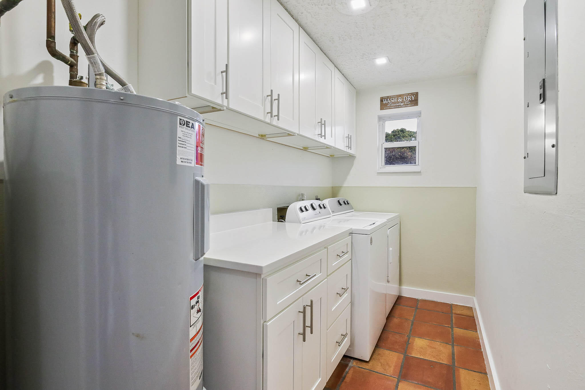 103 East Shannondale Road Cloud Lake, FL 33406 - Photo 24 of 31 a utility room with cabinets washer and dryer