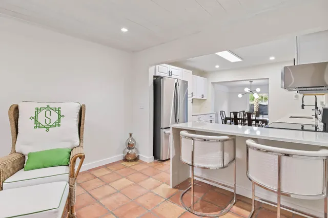 a kitchen with kitchen island a stove a sink and a refrigerator