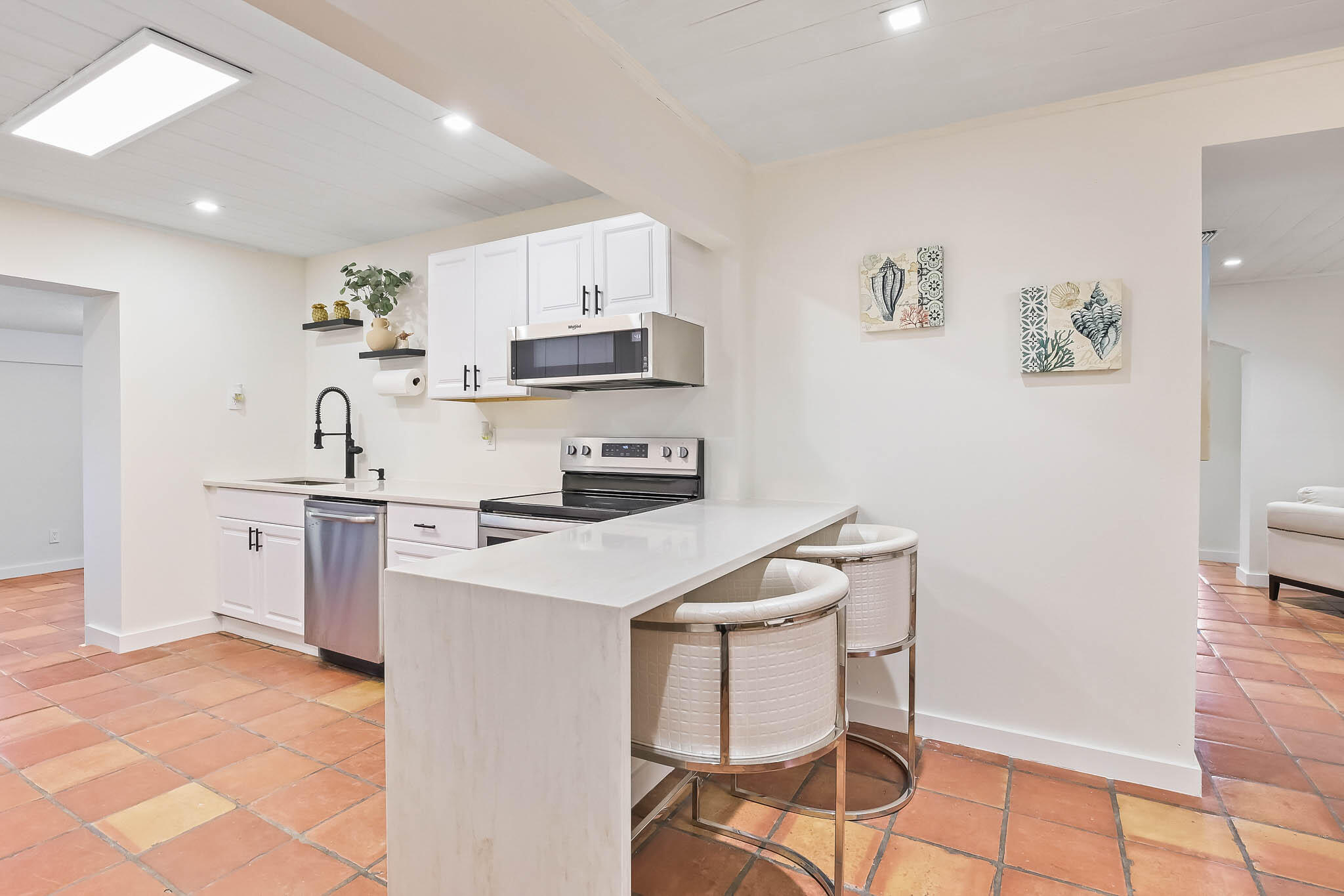 103 East Shannondale Road Cloud Lake, FL 33406 - Photo 7 of 31 a kitchen with a sink a stove and white cabinets
