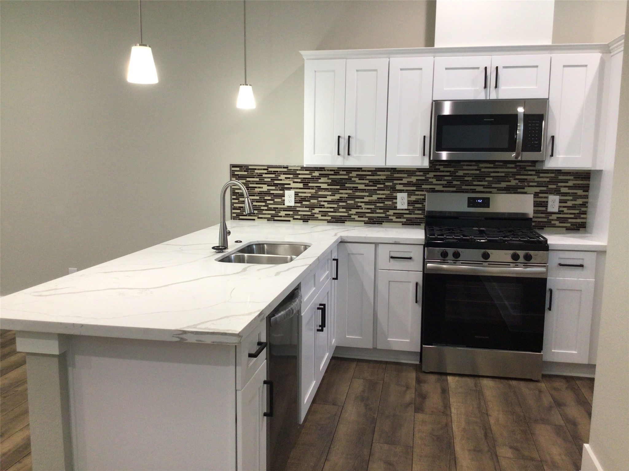 2109 Marnel Road, Unit D Houston, TX 77055 - Photo 9 of 26 a kitchen with stainless steel appliances a stove and a microwave