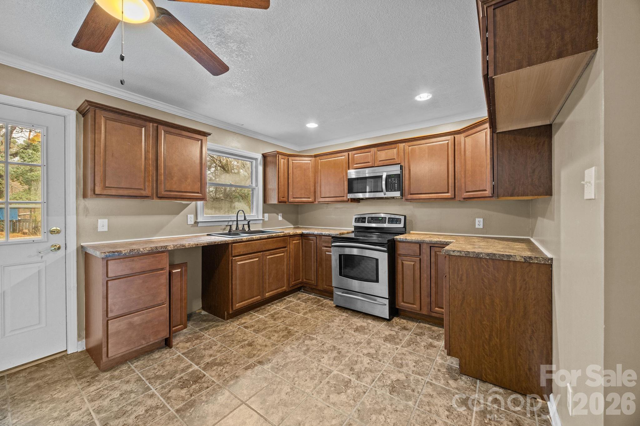 1158 Sunset Court Conover, NC 28613 - Photo 14 of 31 a kitchen with granite countertop a sink cabinets and stainless steel appliances