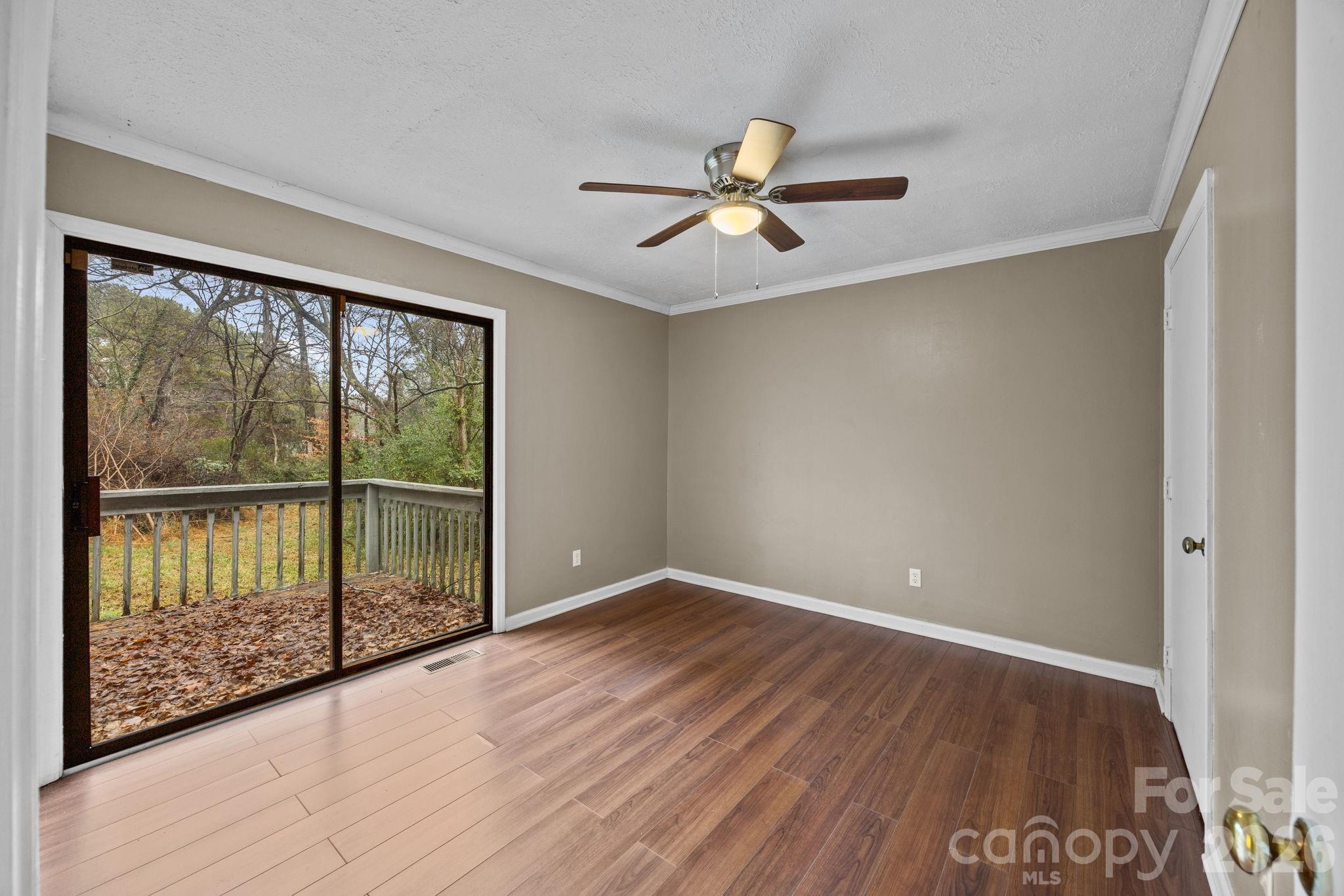 1158 Sunset Court Conover, NC 28613 - Photo 15 of 31 a view of empty room with wooden floor and fan