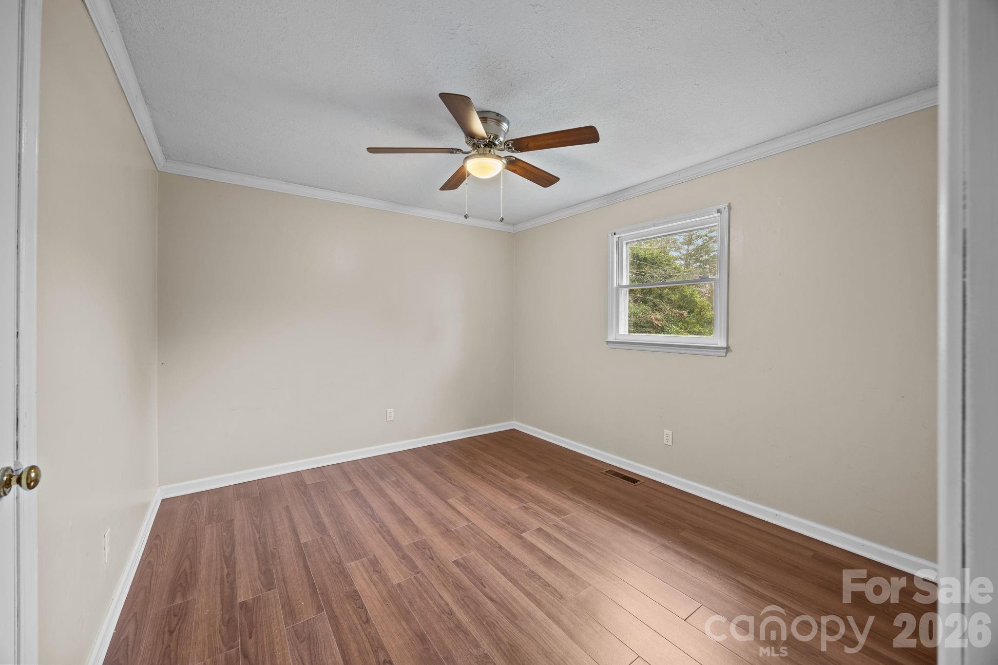 1158 Sunset Court Conover, NC 28613 - Photo 17 of 31 an empty room with a window and a ceiling fan