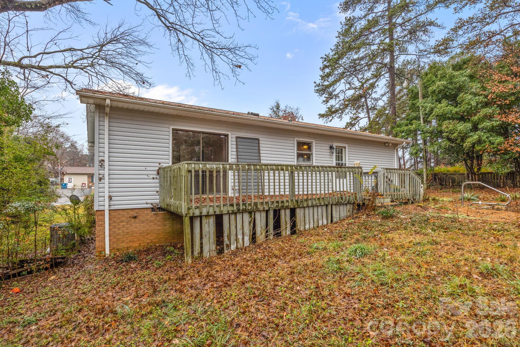 1158 Sunset Court Conover, NC 28613 - Photo 24 of 31 a view of a house with a wooden fence and large trees