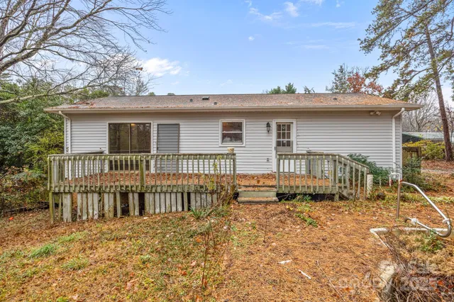 a backyard of a house with large trees