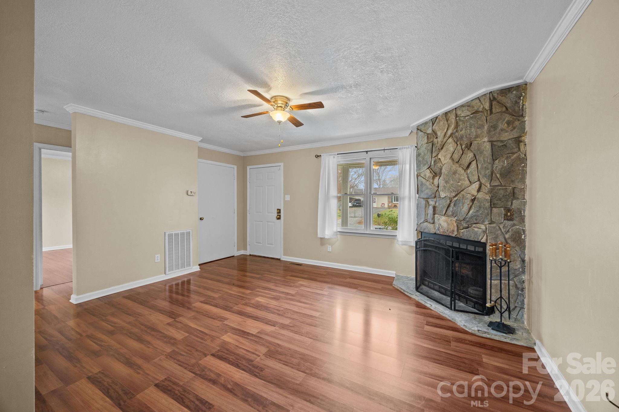 1158 Sunset Court Conover, NC 28613 - Photo 6 of 31 a view of empty room with fireplace and wooden floor
