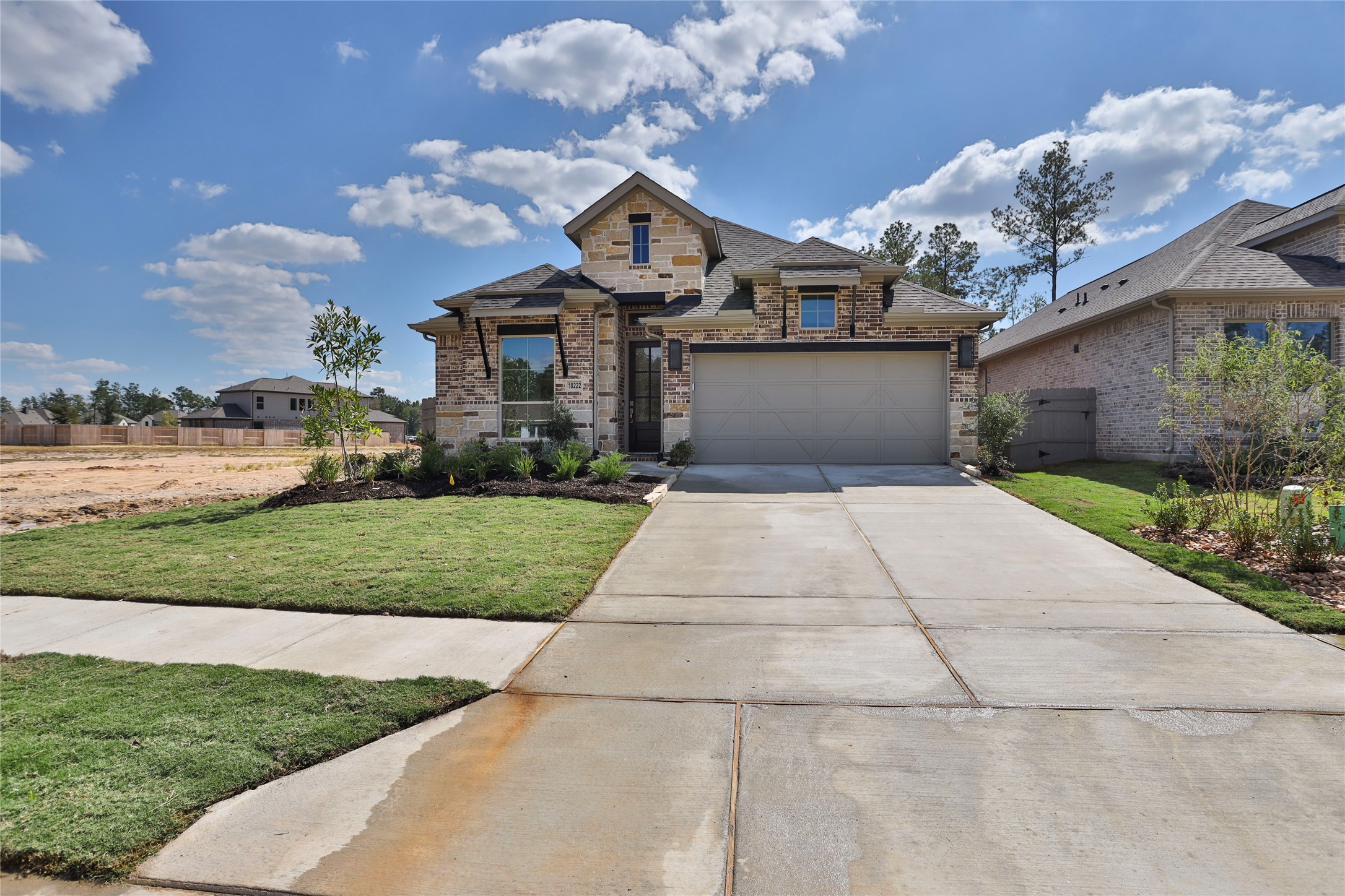 18222 Upper Brook Street Conroe, TX 77302 - Photo 16 of 26 a front view of a house with a yard and garage