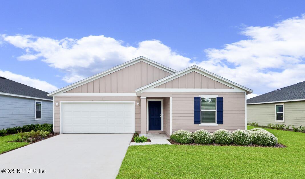 41 Powder Horn Drive Palm Coast, FL 32164 - Photo 1 of 15 a front view of a house with garden