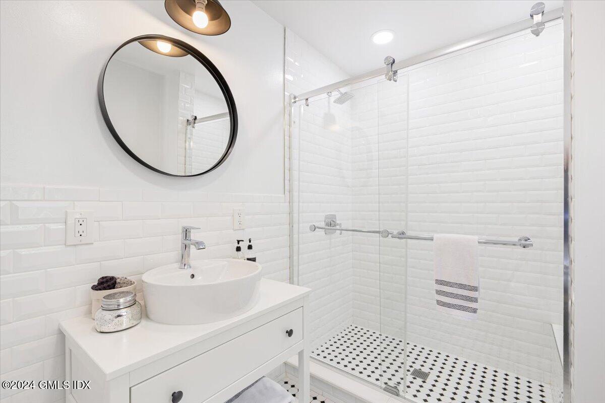 70 Gregory Road Cos Cob, CT 06807 - Photo 23 of 39 a bathroom with a sink a toilet and a mirror