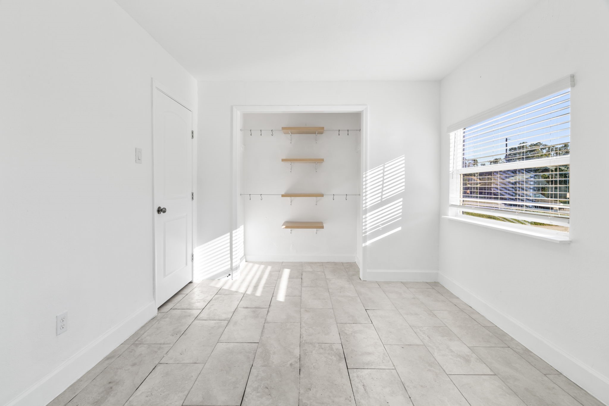 10602 Buffum Street Houston, TX 77051 - Photo 4 of 10 a view of an empty room with a window