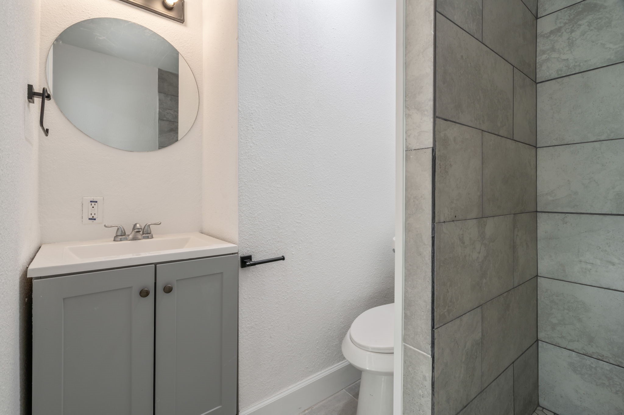 10602 Buffum Street Houston, TX 77051 - Photo 8 of 10 a bathroom with a toilet sink and mirror