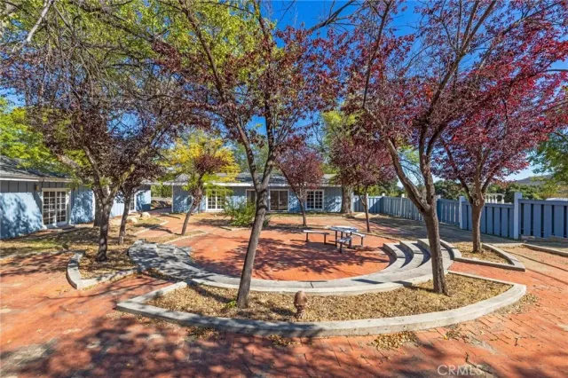 a front view of a house with a yard covered with snow