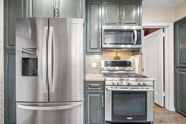 a kitchen with a refrigerator stove and cabinets