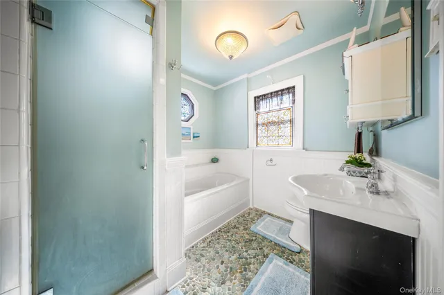 a bathroom with a tub sink and a mirror