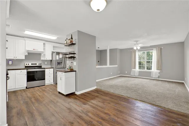 a kitchen with stainless steel appliances a sink and cabinets