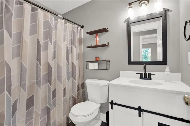 a bedroom with a bed and a ceiling fan