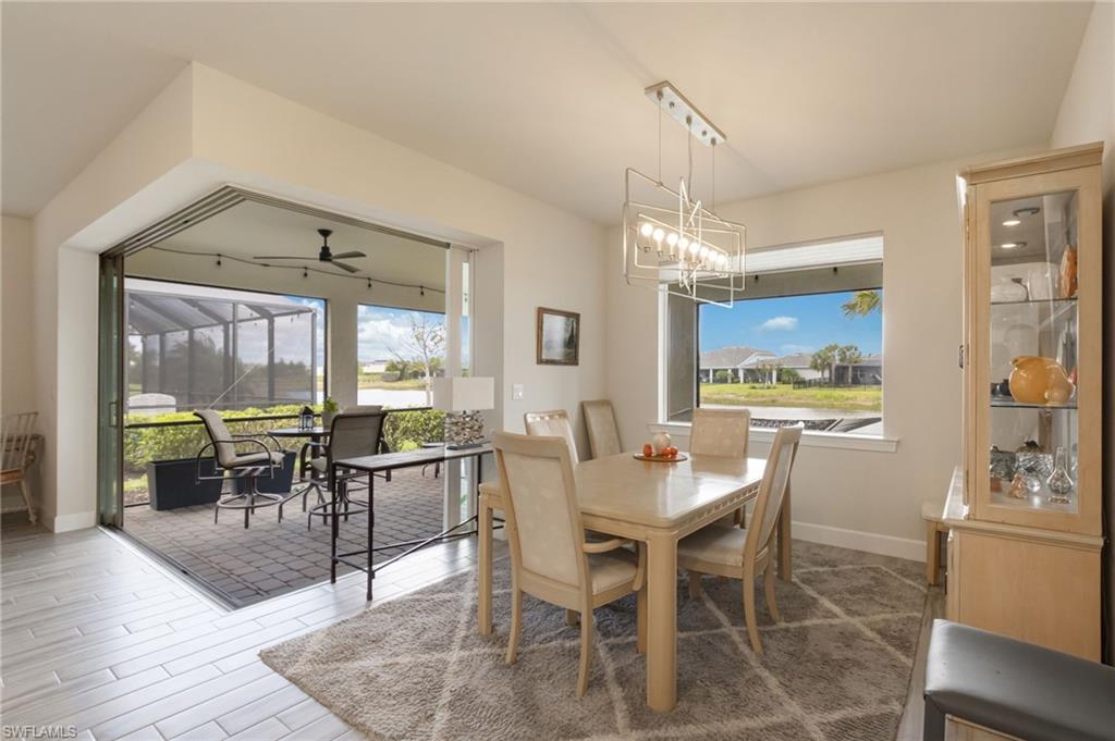 43007 Parkside Court Punta Gorda, FL 33982 - Photo 12 of 44 a dining room with furniture a chandelier and wooden floor