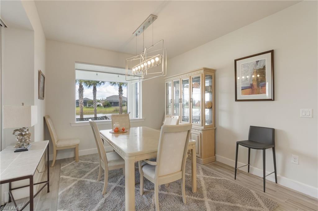 43007 Parkside Court Punta Gorda, FL 33982 - Photo 13 of 44 a dining room with furniture a chandelier and window