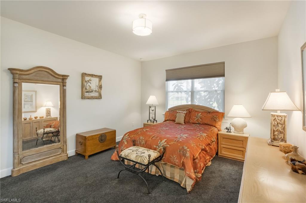 43007 Parkside Court Punta Gorda, FL 33982 - Photo 15 of 44 a bedroom with a bed and a lamp