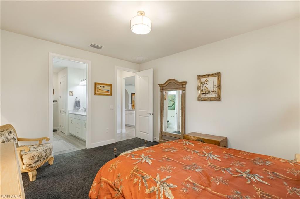 43007 Parkside Court Punta Gorda, FL 33982 - Photo 16 of 44 a bedroom with a bed and a view of bathroom