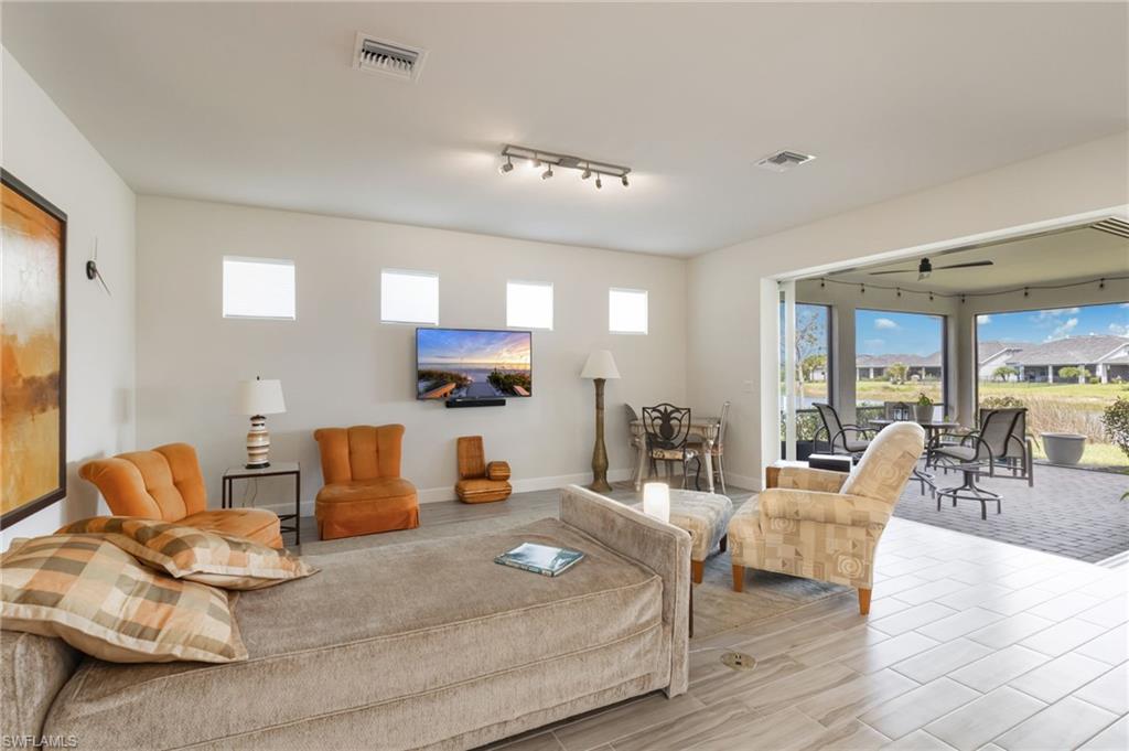 43007 Parkside Court Punta Gorda, FL 33982 - Photo 7 of 44 a living room with furniture kitchen view and a large window