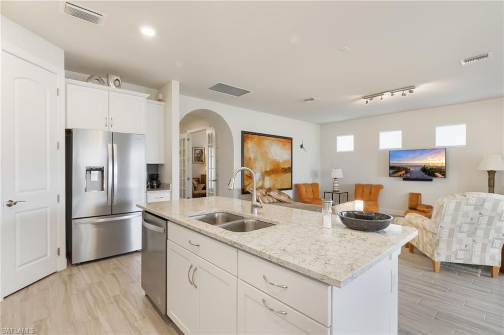 43007 Parkside Court Punta Gorda, FL 33982 - Photo 9 of 44 a kitchen with granite countertop a refrigerator and a sink