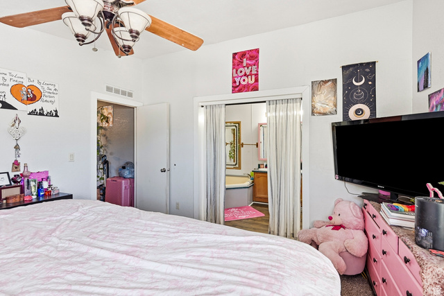 4296 Maple Lane Cedar City, UT 84721 - Photo 17 of 44 White walls with a ceiling fan featuring wooden blades and frosted glass light fixtures