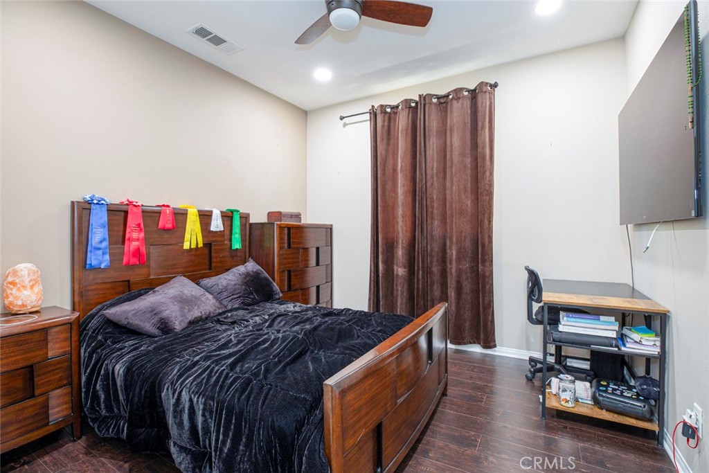 8656 Winnetka Avenue Winnetka, CA 91306 - Photo 17 of 31 a bedroom with bed and a book shelf