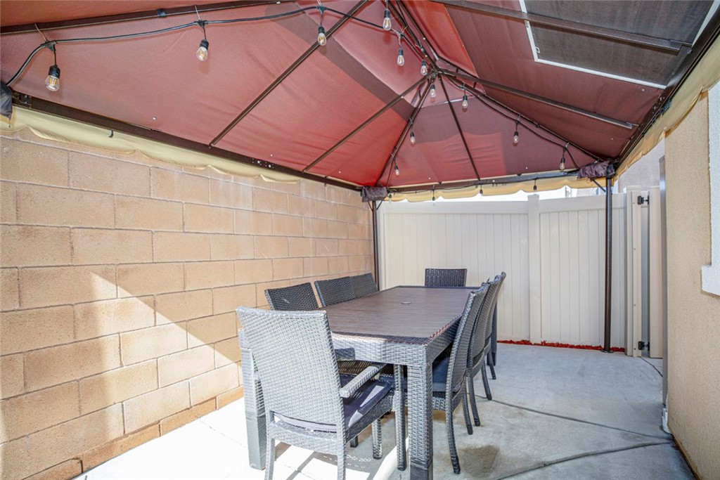 8656 Winnetka Avenue Winnetka, CA 91306 - Photo 25 of 31 a patio table and chairs under an umbrella