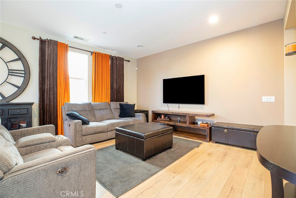 8656 Winnetka Avenue Winnetka, CA 91306 - Photo 5 of 31 a living room with furniture and a flat screen tv