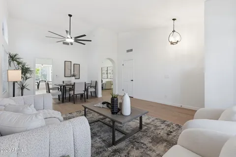 a living room with furniture a window and wooden floor