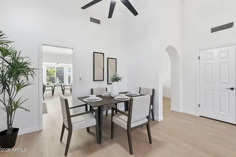 a view of a dining room with furniture and a chandelier