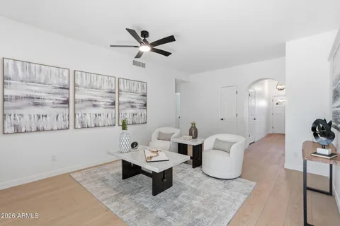 a kitchen with stainless steel appliances a sink a stove and white cabinets