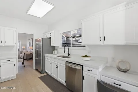 a kitchen with stainless steel appliances a stove a microwave and cabinets